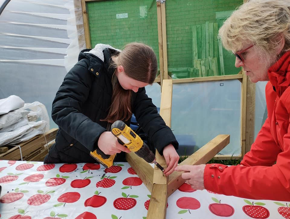 click to see larger image making raised beds and bird feeders at the newbold community growing together community garden