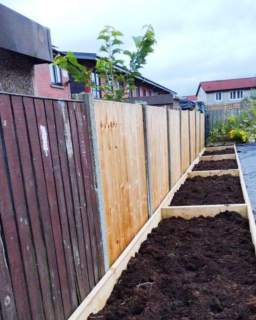 click to see larger image putting in the raised beds at the community garden